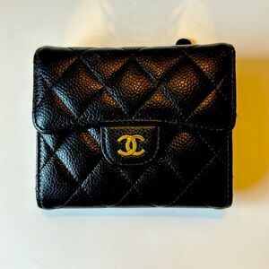 Classic black Chanel flap wallet in caviar leather.